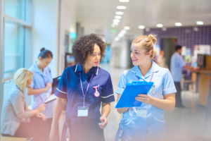 2 nurses walking through a hospital